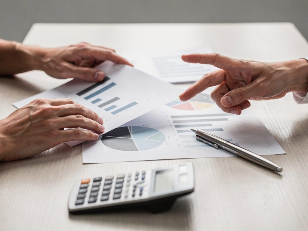 Hands reviewing business charts (illustrative)